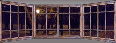 Old wooden window view of the winter landscape with a lanternの写真素材