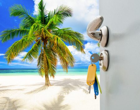 open door with access to the beach view of palmsの写真素材