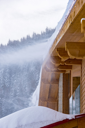 long icicles hanging from the roof of the houseの写真素材