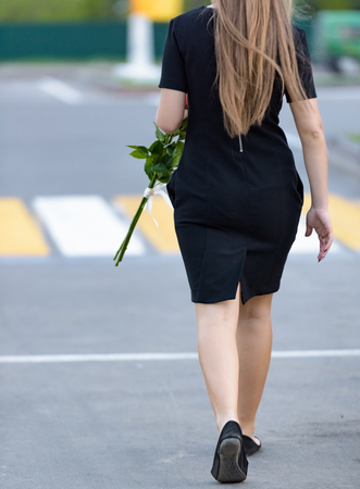 people at a pedestrian crossing across the road in the cityの写真素材