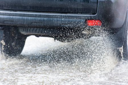 motion car rain big puddle of water spray from the wheels