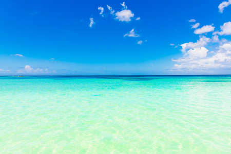 hot day turquoise Caribbean sea blue sky white cumulus cloudの写真素材