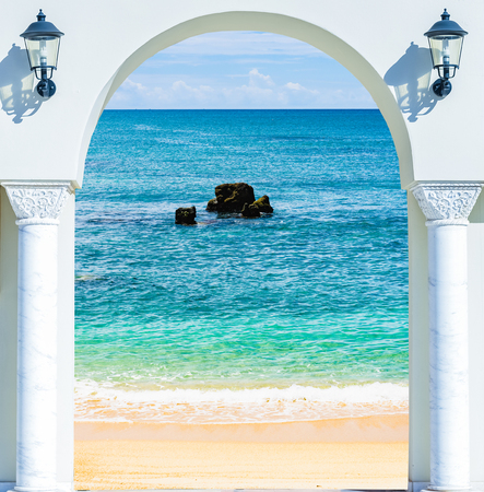 wooden open door arch view of the beach the Caribbean seaの写真素材