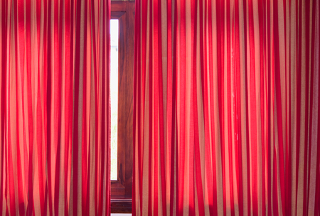 Dense textile red curtain background with foldsの写真素材