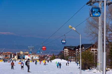Bansko, Bulgaria - February 14, 2019: Winter ski resort Bansko, ski slope, people skiing and mountains view.のeditorial素材