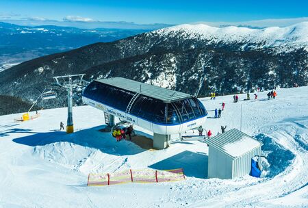 Bulgaria. Bansko. 11 February 2019. Chair ski lift. Elevator lifting people on the mountain ski slope Bansko Bulgaria ski centreのeditorial素材