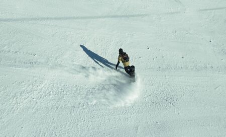 Bulgaria. Bansko. 12 February 2019.  Skier riding down the huge snowfield splashing powder snow.のeditorial素材