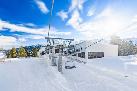 Bulgaria. Bansko. 12 February 2019.Ski resort in Bansko. Snowy ski slopes and  chair ski lifts station in  winter mountain ski resort. Under blue sky on sunny dayのeditorial素材