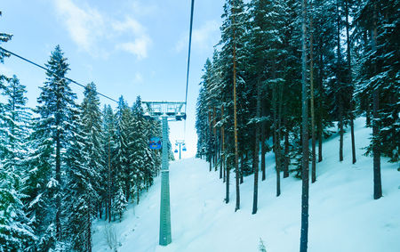 Bulgaria. Bansko. 12 February 2019.Ski resort in Bansko. Snowy ski slopes and  chair ski lifts station in  winter mountain ski resort. Under blue sky on sunny dayのeditorial素材