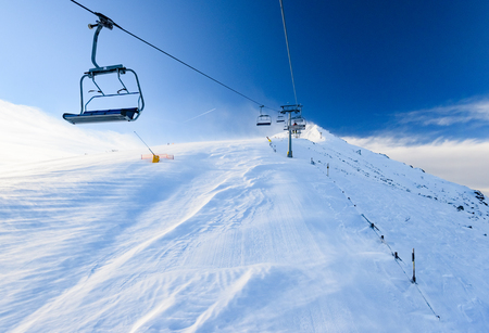 Bulgaria. Bansko. 12 February 2019.Ski resort in Bansko. Snowy ski slopes and  chair ski lifts station in  winter mountain ski resort. Under blue sky on sunny dayのeditorial素材