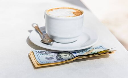 cup of cappuccino with cinnamon on the table with a saucer and spoonの写真素材