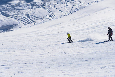 Bulgaria. Bansko. 12 February 2019.skier riding down the huge snowfield splashing powder snow.