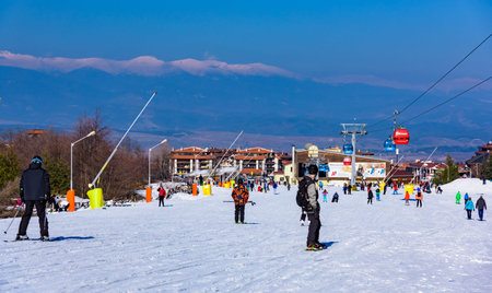 Bansko, Bulgaria - February 14, 2019: Winter ski resort Bansko, ski slope, people skiing and mountains view.のeditorial素材