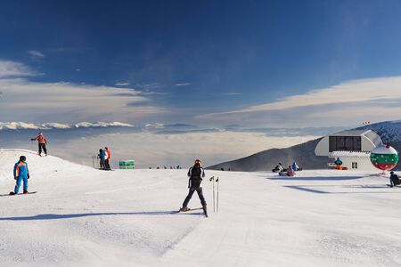 Bansko, Bulgaria - February 14, 2019: Winter ski resort Bansko, ski slope, people skiing and mountains view.のeditorial素材