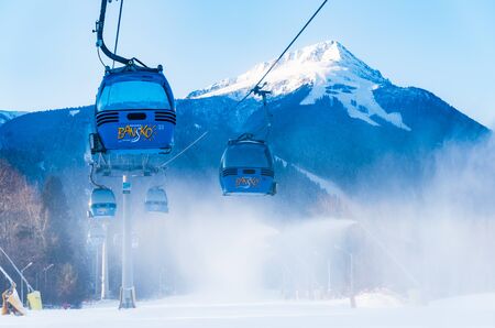 Bansko, Bulgaria - February 09, 2020: Winter ski resort Bansko, ski slope, people skiing and mountains view.のeditorial素材