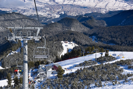 Bansko, Bulgaria - February 10, 2020: Winter ski resort Bansko, ski slope, people skiing and mountains view.のeditorial素材