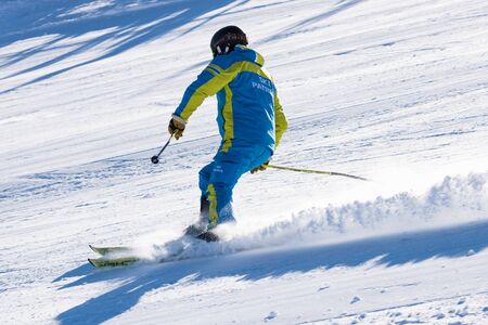 Bulgaria. Bansko. 10 February 2020.  Skier riding down the huge snowfield splashing powder snow.のeditorial素材