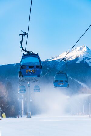 Bansko, Bulgaria - February 09, 2020: Winter ski resort Bansko, ski slope, people skiing and mountains view.のeditorial素材