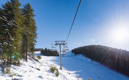 Bulgaria. Bansko. 10 February 2020.Ski resort in Bansko. Snowy ski slopes and  chair ski lifts station in  winter mountain ski resort. Under blue sky on sunny dayのeditorial素材