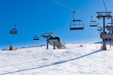 Bulgaria. Bansko. 10 February 2020.Ski resort in Bansko. Snowy ski slopes and  chair ski lifts station in  winter mountain ski resort. Under blue sky on sunny dayのeditorial素材