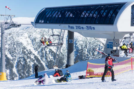 Bulgaria. Bansko. 10 February 2020.Ski resort in Bansko. Snowy ski slopes and  chair ski lifts station in  winter mountain ski resort. Under blue sky on sunny dayのeditorial素材
