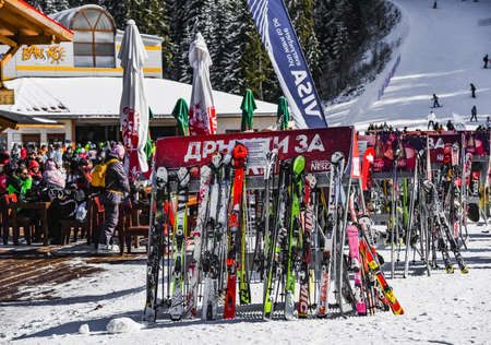 Bulgaria. Bansko. 12 February 2020.Bansko ski station, Kolarski ski lift at Banderishka polyana, skiers on ski slopes, mountain. With pine trees, people. Snowのeditorial素材