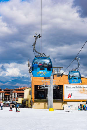 Bansko, Bulgaria - February 14, 2020: Winter ski resort Bansko, ski slope, people skiing and mountains view.のeditorial素材