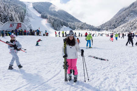Bansko, Bulgaria - February 14, 2020: Winter ski resort Bansko, ski slope, people skiing and mountains view.のeditorial素材