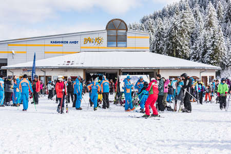 Bansko, Bulgaria - February 14, 2020: Winter ski resort Bansko, ski slope, people skiing and mountains view.のeditorial素材