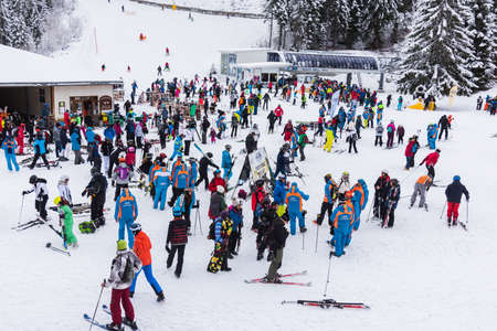 Bansko, Bulgaria - February 14, 2020: Winter ski resort Bansko, ski slope, people skiing and mountains view.のeditorial素材