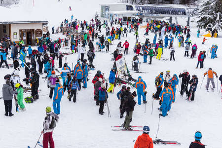 Bansko, Bulgaria - February 14, 2020: Winter ski resort Bansko, ski slope, people skiing and mountains view.のeditorial素材