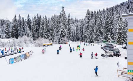 Bansko, Bulgaria - February 14, 2020: Winter ski resort Bansko, ski slope, people skiing and mountains view.のeditorial素材