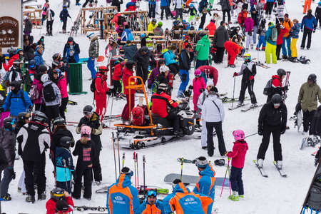 Bansko, Bulgaria - February 14, 2020: Winter ski resort Bansko, ski slope, people skiing and mountains view.のeditorial素材