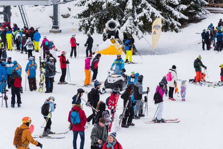 Bansko, Bulgaria - February 14, 2020: Winter ski resort Bansko, ski slope, people skiing and mountains view.のeditorial素材