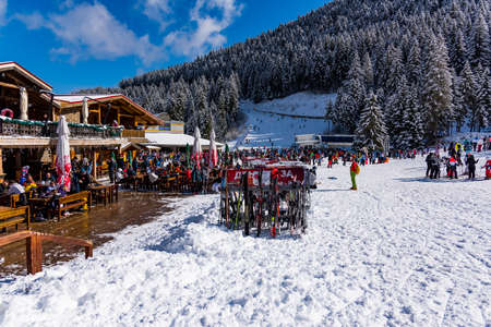 Bansko, Bulgaria - February 14, 2020: Winter ski resort Bansko, ski slope, people skiing and mountains view.のeditorial素材