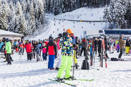 Bansko, Bulgaria - February 14, 2020: Winter ski resort Bansko, ski slope, people skiing and mountains view.のeditorial素材