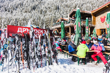 Bulgaria. Bansko. 12 February 2020.Bansko ski station, Kolarski ski lift at Banderishka polyana, skiers on ski slopes, mountain. With pine trees, people. Snowのeditorial素材