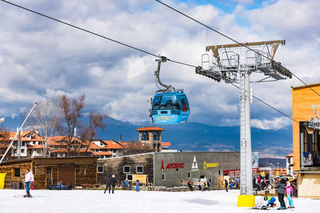 Bansko, Bulgaria - February 14, 2020: Winter ski resort Bansko, ski slope, people skiing and mountains view.のeditorial素材
