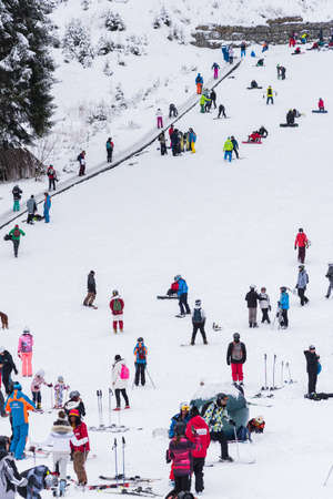 Bansko, Bulgaria - February 14, 2020: Winter ski resort Bansko, ski slope, people skiing and mountains view.のeditorial素材