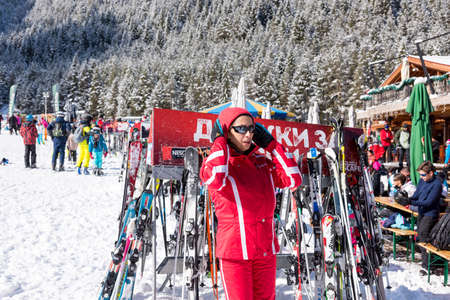 Bansko, Bulgaria - February 14, 2020: Winter ski resort Bansko, ski slope, people skiing and mountains view.のeditorial素材