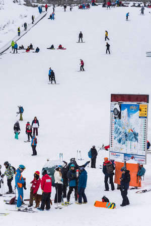Bansko, Bulgaria - February 14, 2020: Winter ski resort Bansko, ski slope, people skiing and mountains view.のeditorial素材