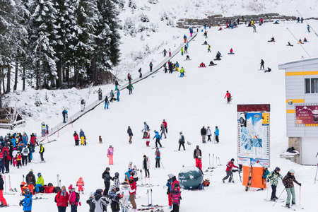 Bansko, Bulgaria - February 14, 2020: Winter ski resort Bansko, ski slope, people skiing and mountains view.のeditorial素材