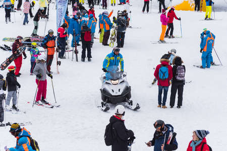 Bansko, Bulgaria - February 14, 2020: Winter ski resort Bansko, ski slope, people skiing and mountains view.