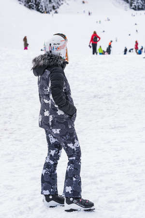 Bansko, Bulgaria - February 14, 2020: Winter ski resort Bansko, ski slope, people skiing and mountains view.のeditorial素材