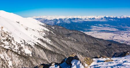 mountain peaks covered with snow illuminated by a bright sunの写真素材