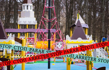 playground is covered with a signal tape epidemic coronovirus COVID19. all small children are...