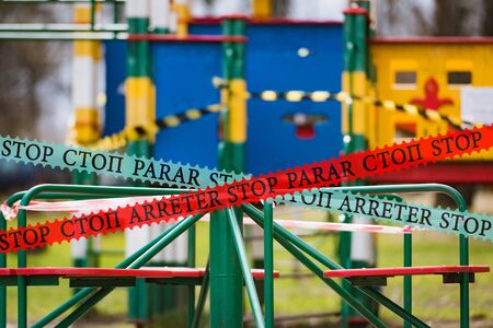playground is covered with a signal tape epidemic coronovirus COVID19. all small children are quarantined at homeの写真素材