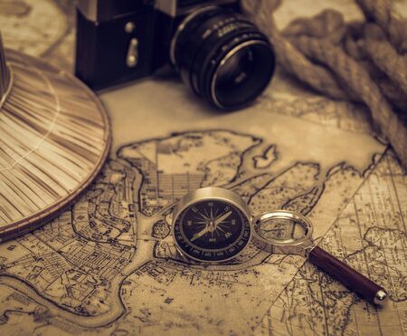 planning travel on vacation along with a map, compass, camera, notepad.の写真素材