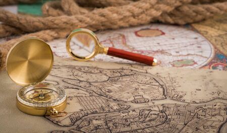 compass and magnifying glass lie on the topographic mapの写真素材