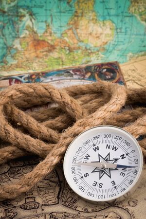 old burnt World Map with compass on a white backgroundの写真素材